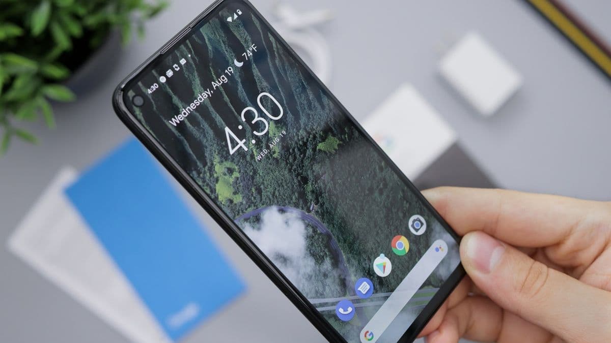 A hand holding a black Android smartphone